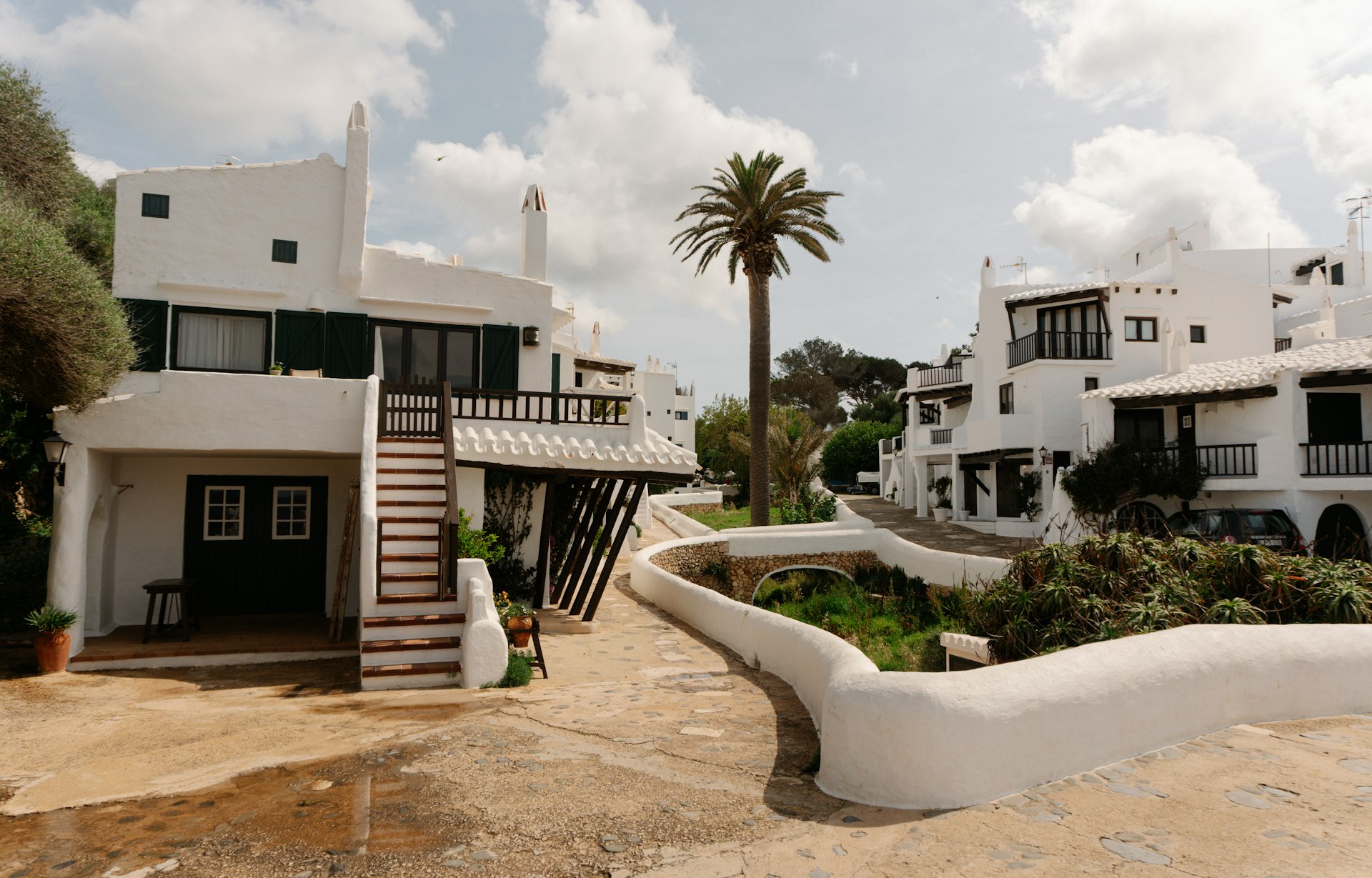 White buildings line a charming, sunny street.
